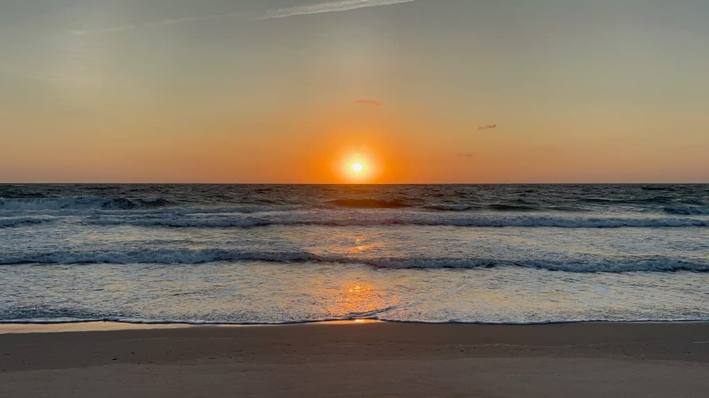 Sunrise over a calm beach